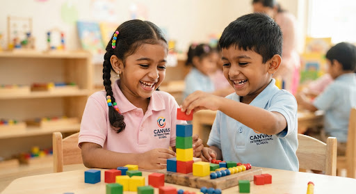 Close up shot of South Asian kindergarten students in a bright school playing with educational wooden math cubes and counting beads. A cute boy and girl are laughing together as they construct a small colored tower. High quality warm lighting with pastel tones.